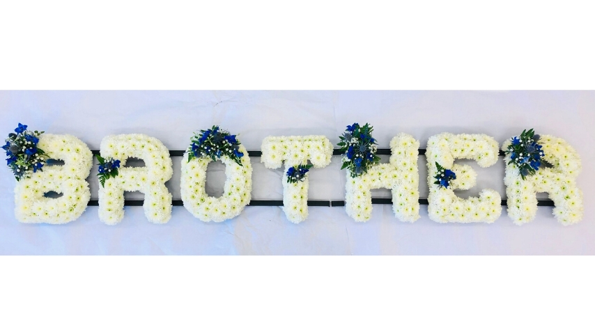 <h2>BROTHER White Funeral Letters | Funeral Flowers</h2>
<ul>
<li>Approximate Size W 210cm H 30cm</li>
<li>Hand created BROTHER tribute letter in white</li>
<li>Flower spray can be made in any colour (shown in blue on this picture)</li>
<li>To give you the best we may occasionally need to make substitutes</li>
<li>Funeral Flowers will be delivered at least 2 hours before the funeral</li>
<li>For delivery area coverage see below</li>
</ul>
<h2><br />Liverpool Flower Delivery</h2>
<p>We have a wide selection of Funeral Tributes offered for Liverpool Flower Delivery. Funeral Tributes can be provided for you in Liverpool, Merseyside and we can organize Funeral flower deliveries for you nationwide. Funeral Flowers can be delivered to the Funeral directors or a house address. They can not be delivered to the crematorium or the church.</p>
<br>
<h2>Flower Delivery Coverage</h2>
<p>Our shop delivers funeral flowers to the following Liverpool postcodes L1 L2 L3 L4 L5 L6 L7 L8 L11 L12 L13 L14 L15 L16 L17 L18 L19 L24 L25 L26 L27 L36 L70 If your order is for an area outside of these we can organise delivery for you through our network of florists. We will ask them to make as close as possible to the image but because of the difference in stock and sundry items, it may not be exact.</p>
<br>
<h2>Liverpool Funeral Flowers | Letters</h2>
<p>This BROTHER tribute letter is made using a mass of white double spray chrysanthemums edged with foliage and featuring a spray of flowers in any colour (shown in Blue here).</p>
<br>
<p>Name Funeral Tributes or Letter Funeral Flowers are a way to create a tribute that is truly unique and specially designed for a loved one.</p>
<br>
<p>These are usually selected by family members to indicated their relation to their loved one. Sometimes groups of friends or groups of workplace colleagues select a word they associate with the deceased.</p>
<br>
<p>Letter or Name Funeral Tributes can be done in a massed style of white flowers with small sprays or as mixed flowers where the letters are all written in a variety of flowers of the same colour palette.</p>
<br>
<p>The flowers are arranged in floral foam, which means the flowers have a water source so they look the very best on the day.</p>
<br>
<p>Contents of tribute: 85 White Spray Chrysanthemums. The Blue spray will contain seasonal blue and white flowers such as roses, lisianthus, spray roses, eryngium and gypsophila - different coloured sprays will have similar types of flowers and mixed seasonal foliage.</p>
<br>
<h2>Best Florist in Liverpool</h2>
<p>Trust Award-winning Liverpool Florist, Booker Flowers and Gifts, to deliver funeral flowers fitting for the occasion delivered in Liverpool, Merseyside and beyond. Our funeral flowers are handcrafted by our team of professional fully qualified who not only lovingly hand make our designs but hand-deliver them, ensuring all our customers are delighted with their flowers. Booker Flowers and Gifts your local Liverpool Flower shop.</p>
<p><br /><br /><br /></p>
<p><em>Debra G - Review from Yell - Funeral Flowers Liverpool</em></p>
<br>
<p><em>This 5 Star review was from Yell.com - Booker Flowers and Gifts - Reviews</em></p>
<br>
<p><em>Fleur and her team made the flowers for my Dad's funeral. I knew I wanted something quite specific but was quite unsure how to execute the idea. Fleur understood immediately what I was hoping to achieve and developed the ideas into amazingly beautiful flowers that were just perfect. I honestly can't recommend her highly enough - she created something outstanding and unique for my Dad. Thanks Fleur </em></p>
<br>